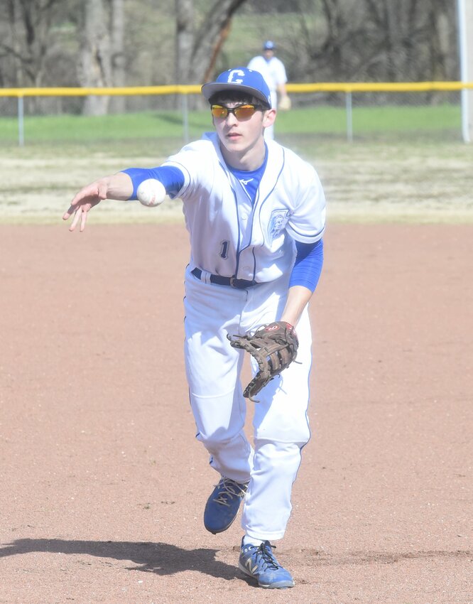 Cotter's Brayden Adams flips to first base for an out during a recent game at Yellville. The Warriors have won 11 of their past 12 games.
