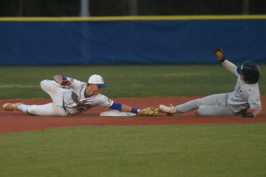 Mountain Home's Dawson Dunlap tags Greenwood's Austin Bercher on a steal attempt at second base during the Bombers' sweep of the Bulldogs on Tuesday.