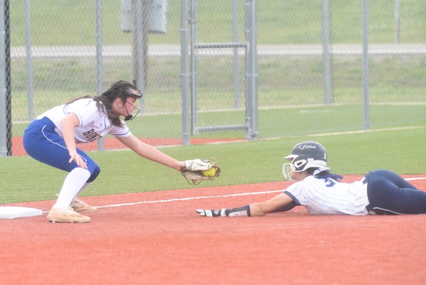 Mountain Home's Laken Anderson tags out a Greenwood runner at third base during a recent home game.