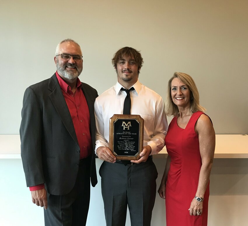 Mountain Home's Robert Dover (middle), is presented with the Jim Holsted Memorial Athlete of the Year plaque by Mike and Susan Stockton on Tuesday night.