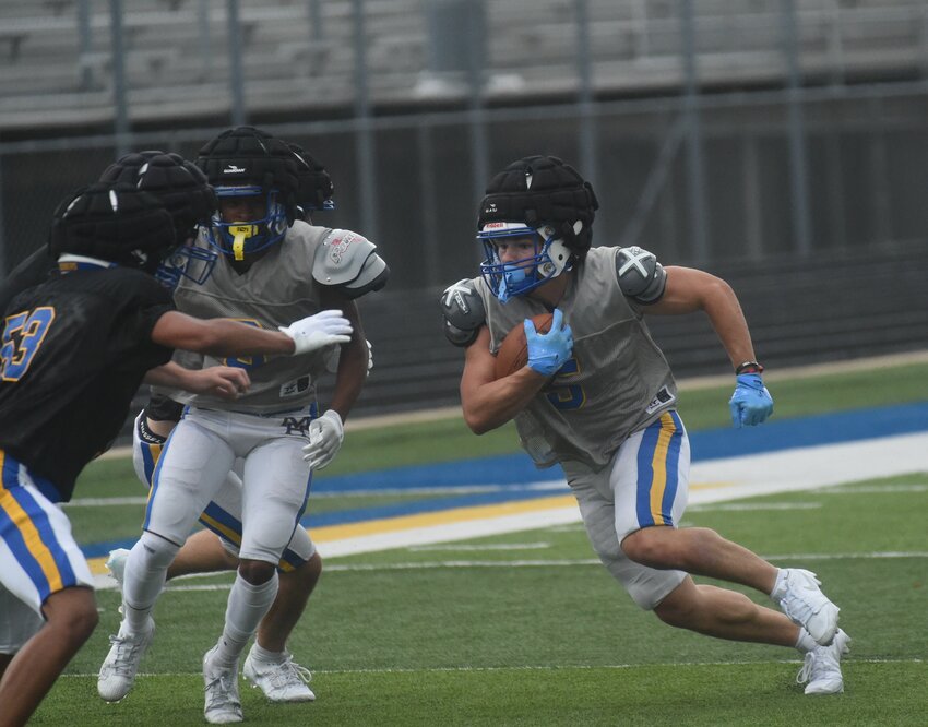 Mountain Home's Barrett Miller carries during the Bombers' annual spring scrimmage on Tuesday night at Bomber Stadium.