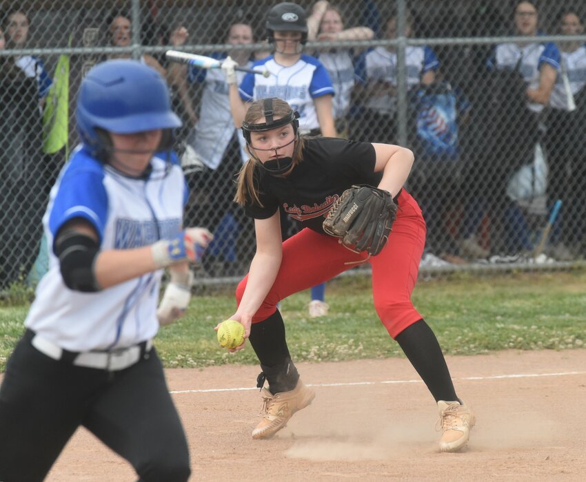 Flippin's Adrianne Benedict fields the ball as Cotter's Emma Jones runs to first base earlier this season. Both Benedict and Jones are members of the Baxter Bulletin All-Area team.