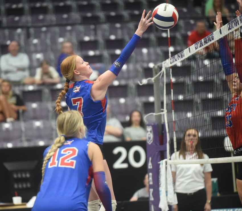 Yellville-Summit's KJ Moore tips the ball over the net during the Arkansas High School Coaches Association All-Star volleyball match on Friday.