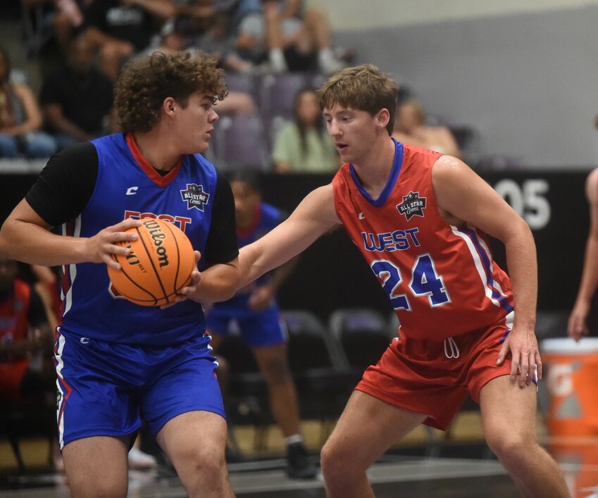 Mountain Home's Braiden Dewey (right) defends West Side's Jacob Carlton on Saturday in the Arkansas High School Coaches Association All-Star Games in Conway.