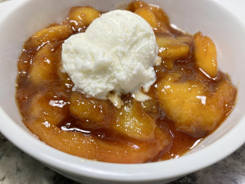 &nbsp;Peaches are saut&eacute;ed with brown sugar, butter, cinnamon and nutmeg to create Peaches al la Caramel and served with ice cream.   Linda Masters/BaxterBulletin