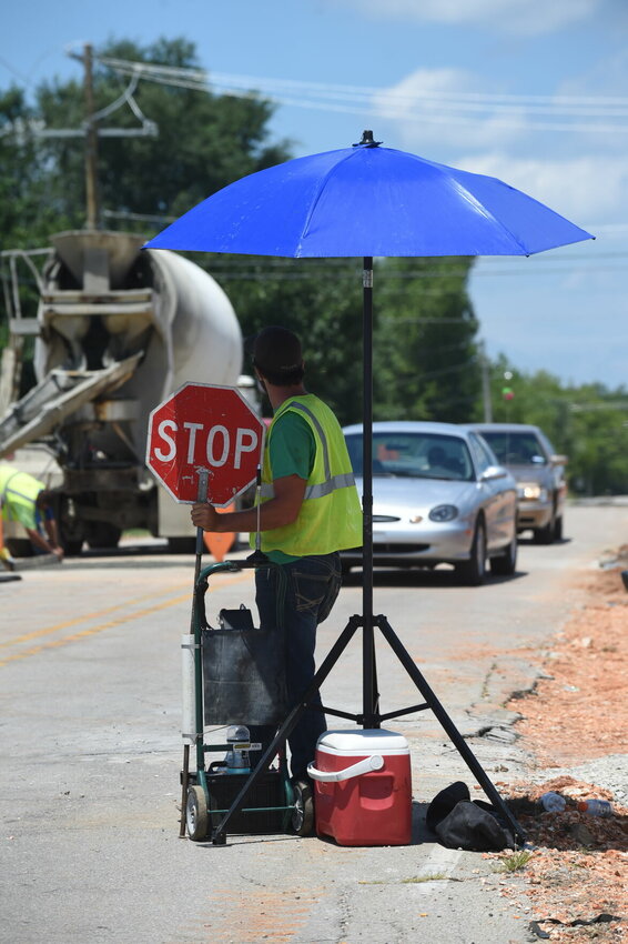 A worker on a local road crew seeks relief from the blistering sun in this Bulletin file photo. Intense heat is once again set to blast the Twin Lakes Area as the dog days of summer arrive.   Bulletin File Photo