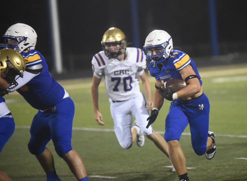 Mountain Home's Connor Schulz (right) carries the ball during the recent scrimmage against Central Arkansas Christian. Schulz scored two touchdowns in Mountain Home's JV win over West Plains on Monday.