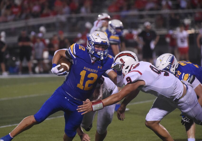 Mountain Home's Dawson Dunlap (12) carries during the Bombers' victory against West Plains on Friday.