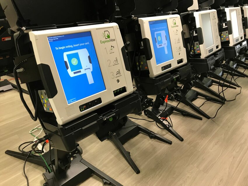 A row of voting machines is seen at the Baxter County Election Commission headquarters. Justice Dennis Frank made an report on his recent trip to the Arkansas Association of Counties' annual conference at the recent meeting of the Baxter County Quorum Court.   Scott Liles/The Baxter Bulletin