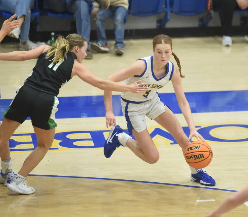 Mountain Home's Jayla Yonkers drives past Van Buren's Aspen Cone during the Lady Bombers' 60-53 victory on Friday night.