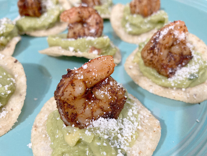 Cutline: The guacamole spread in these Roasted Shrimp Mini Tostadas quells the heat of the spicy marinade.