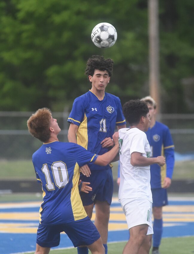 Mountain Home's Adrian Benito Gonzalez (11) heads the ball during a recent home match as teammate Jacob Bzdel (10) reads the play. The Bombers defeated both Farmington and Greenwood last week to clinch a state tournament berth.
