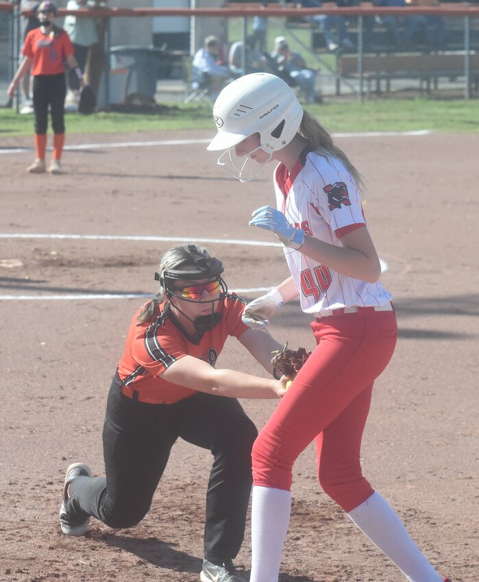 Viola's Joey Harber attempts a tag on Norfork's Kinley Robertson at first base during a conference game earlier this season.