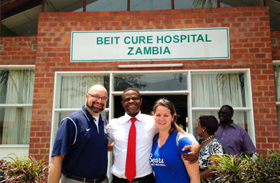 Emir and Hana Caner stand with Dr. Kachinga Sichizyaat, a neurosurgeon at Beit Cure Hospital in Lusaka, Zambia. Truett-McConnell College partners with the hospital to send nursing students there between their junior and senior years.