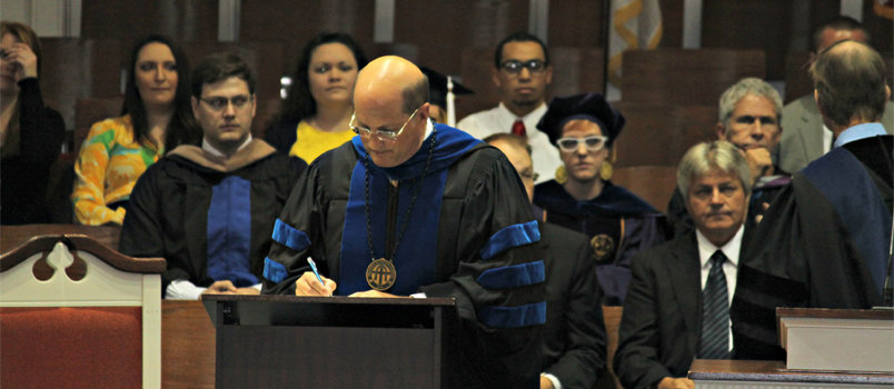Brewton-Parker College President Tim Echols signs the Baptist Faith and Message 2000.