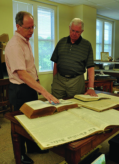 GBC Archivist Charles Jones, left, and Index Editor Gerald Harris, right, look over a variety of sizes of The Index during the past two centuries. The paper frequently changed size and format due to mailing costs and availability of newsprint. During the Civil War it advertised it was seeking rags to add to the newsprint to provide a better quality paper. JOE WESTBURY/Index