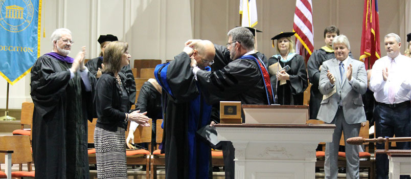 Board of Trustees Chair Ray Sullivan, right, presents Steven Echols with a Bible and the presidential medallion, welcoming him as the college’s 17th president. SARAH BULLARD/BPC