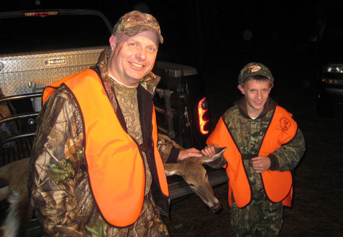 Mark Strange, state ministry in GBC Communication Services, stands with his son Logan, who got his first deer on one of the Father/Son Hunts offered through Legacy Outdoor Ministries. LOM/Special