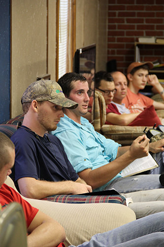Joseph Thompson, center in blue shirt, speaks during a men’s Bible study during a Baptist Collegiate Ministry meeting at Abraham Baldwin Agricultural College. RYANE SELLERS/Special