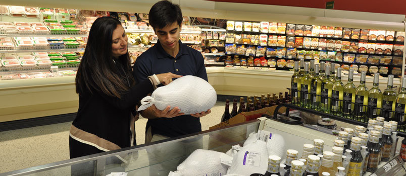 Ozden Mansoori, left, picks out a Thanksgiving turkey with her son, Ashkan David, earlier this week. Mansoori is a native of Turkey and is married to Kevin Mansoori, pastor of Georgia Baptist’s first Iranian congregation meeting at First Baptist Church of Alpharetta. While Ashkan David is born to parents of two nationalities, he says simply … and proudly … “I’m American.” JOE WESTBURY/Index