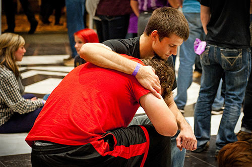 Students pray at the Move conference held after Christmas each year in Macon.