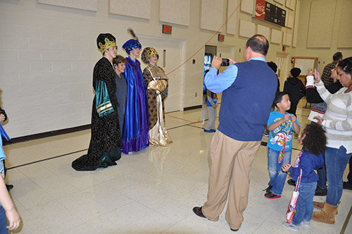 The Three Kings – Connor Newman, Noah Hensley, and Cameron Newman, left to right – pose for photos with the children. JOE WESTBURY/Index