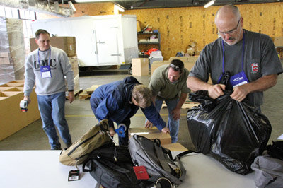Left to right, Baptist Collegiate Ministries directors David Kirkland (Georgia College and State University), Penny Chestnut (ABAC), Tony Branham (Armstrong Atlanta State University and Coastal College of Georgia), and Nathan Byrd (UGA) prepare to ship backpacks collected by Georgia Baptists for Appalachian schoolchildren. GBC COMMUNICATIONS/Special