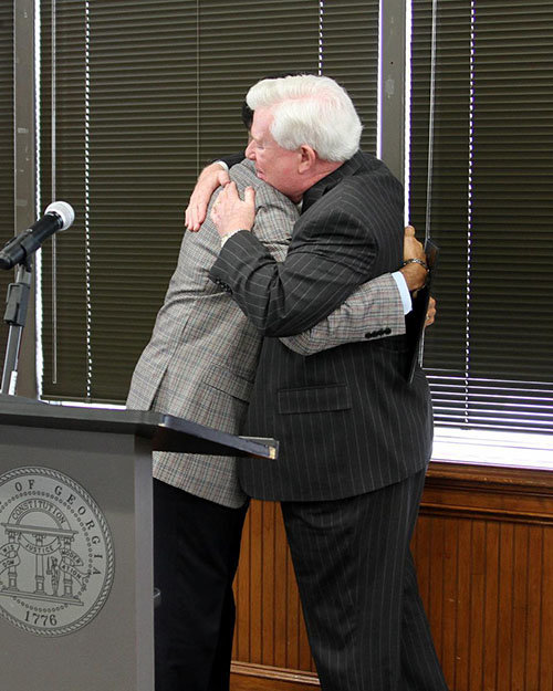 Cochran and Georgia Baptist Mission Board Executive Director J. Robert White embrace following Cochran's message to attendees. GERALD HARRIS/Index