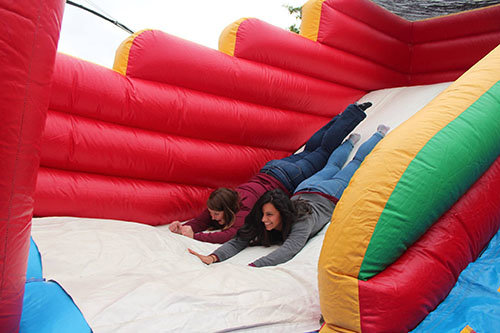 NCC intern Sabrina Thompson, left, test out an inflatable at the church's community carnival alongside staff member Danielle Gonzalez. NEW CITY/Special