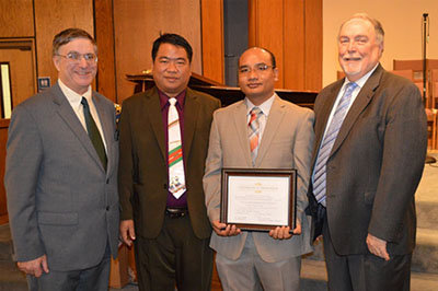 Standing left to right at the Feb. 28 ordination service are Keith Pisani, pastor of Pine Lake Baptist Church,; Pastor Thawng Boi of Myanmar (formerly Burma); Thawng K. Kim, psator of Zomi Baptist Church of Atlanta; and Jerry Baker of Intercultural Church Planting and Missions Ministry of the Georgia Baptist Mission Board.