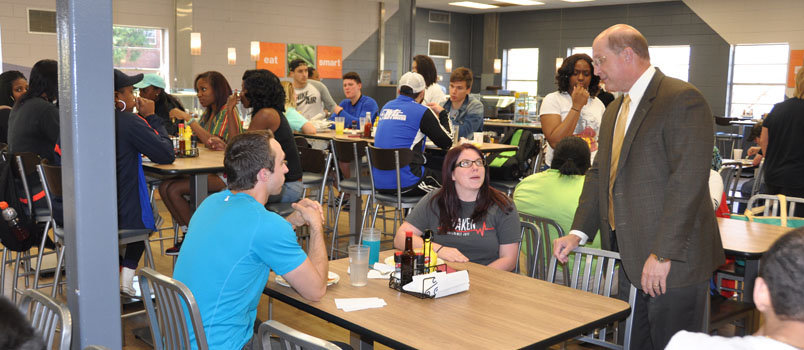 J. T. Robinson of Guyton, left, and Alexys Aldridge of Pearson, right, visit with BPC President Steve Echols in the cafeteria. Robinson is a sophomore business management major and Aldridge is a senior biology manor.