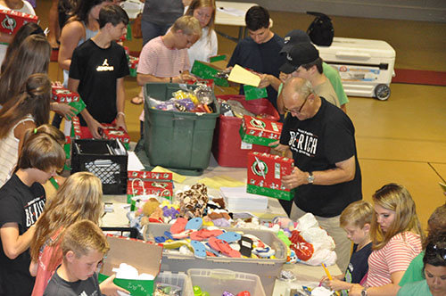 Mathis, center right, helps during a packing party for Operation Christmas Child last year. PVSBC/Special