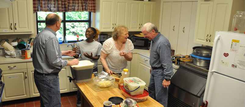 Tony Gray, right, outgoing BCM campus minister at Columbus State University, enjoys a light-hearted moment with Margaret Higdon, ministry assistant, in the BCM kitchen. Also helping to assemble the noon meal is incoming campus minister Rick Jenkins, left, and student Tierra McCray, a senior from Miami, FL. JOE WESTBURY/Index