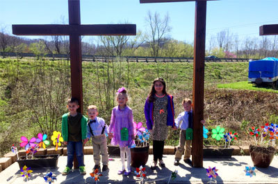 A group of children from Calvary Baptist Church in Chapmanville, WV, planted pinwheels around the three crosses on the church’s lawn during the annual Pinwheels for Prevention against child abuse emphasis. BP/Special