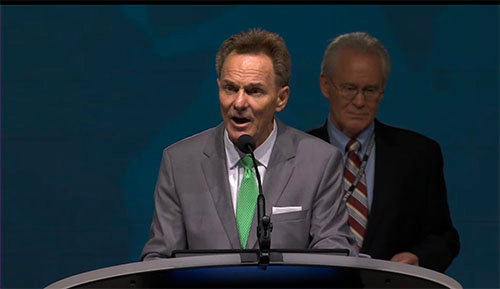 President Ronnie Floyd conducts business with aid from chief parliamentarian Barry McCarty, background.