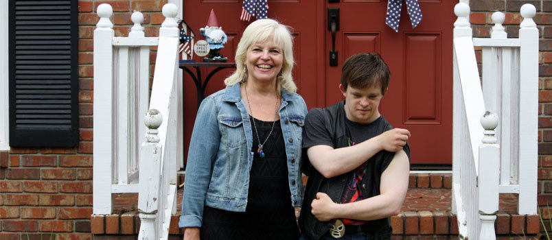 Zach Grist, who has been known to moonlight as Superman, shows off his muscles next to his mother, Kim. GRIST FAMILY/Special