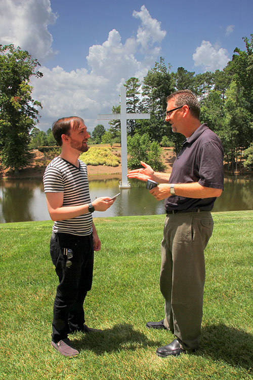 At left Josh, a Duluth office worker and Lawrenceville college student, chats with Georgia Baptist Mission Board state missionary Buck Burch. The cross in front of the Missions and Ministry Center had been determined a "gym" for Pokemon GO players such as Josh. BRYAN NOWAK/Special