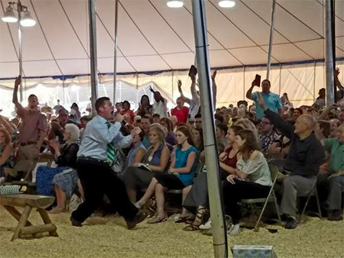 Evangelist C.T. Townsend becomes animated during his message at the Burlington Revival on July 19. MICHAEL D. ABERNETHY/Times-News Burlington,NC