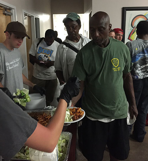 The food line at the House of Luke stretched back when a group of students from First Baptist Woodstock ministered there recently. GERALD HARRIS/Index