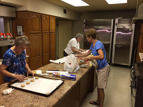Left to right, Pam Davidson, Gayle Marshall, and Yvonne Mullis bake cookies to be delivered to downtown businesses in Dublin. The missions outing was part of Jefferson Street Baptist Church's Summer of Service, and well-received to the point that it's set to become a regular part of the church's ministry. DARREN TALLEY/Special