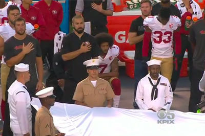 San Francisco 49ers quarterback Colin Kaepernick kneels during the National Anthem Thursday night in San Diego. Screen grab via ESPN