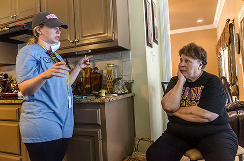 Sarah Farley, associate director of Louisiana State University's Baptist Collegiate Ministry and former Georgia Baptist state missionary in Collegiate Ministries, discusses mold removal with homeowner Paulette LaCombe, Sept. 3 at a flood-damaged home in Denham Springs, LA. Farley helped organize a massive mud out event, bringing more than 450 student members of LSU Baptist Collegiate Ministry and other collegiate church ministries from six states, to help survivors of the mid-August flood. CARMEN K. SISSON/NAMB
