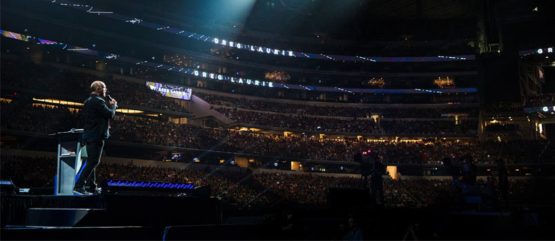 Greg Laurie speaks at AT&T Stadium in Dallas, TX in March. In addition to the 82,000 people attending the event in person, more than 180,000 participated via remote venues in all 50 states and 123 countries. TREVER HOEHNE/Harvest Ministries