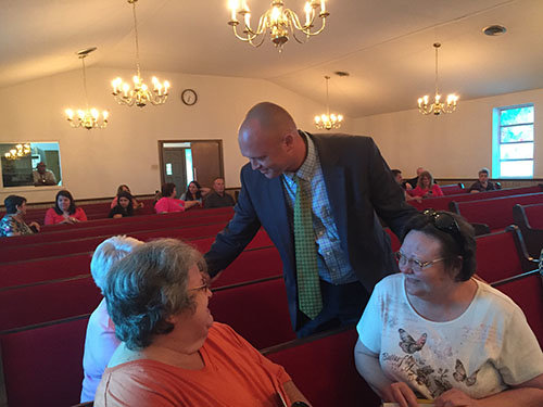 Stafford talks with some early arrivals for a recent revival service at Anderson Drive Baptist Church in Jesup. GERALD HARRIS/Index