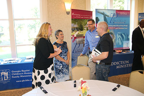 Left to right, Alice Bagley and Sandra Hammonds of the Georgia Baptist Children's Home and Family Ministries talks with Buck Burch, of Cooperative Program Giving and Stewardship, and Chad Mantooth, pastor of First Baptist Church in Winder. SCOTT BARKLEY/Index