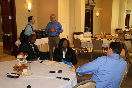 State missionary Jonathan Jordan, Groups and Faith Development, chats with Clarence and Helen Potter of City of Blessings Church in Covington. In the background, Stuart Lang of Community Missions and Disaster Response talks with First Baptist Snellville pastor Brian Boyles. SCOTT BARKLEY/Index