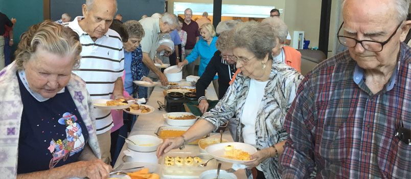 Members of Eastside Baptist Church's 10:10 Club enjoy a traditional Baptist covered dish luncheon. GERALD HARRIS/Index