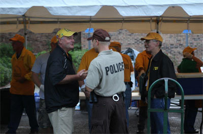 A police officer visits with a disaster relief volunteer in Brunswick. MARK STRANGE/Special