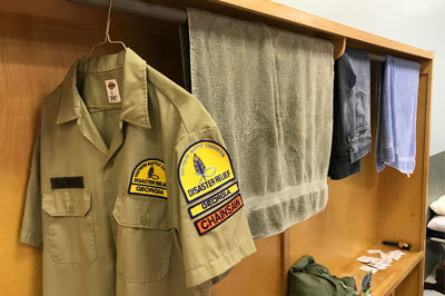 A Georgia chain saw member's shirt hangs in a makeshift closet at the Savannah Baptist Center. The Center has been pressed into service as a sleeping area and cafeteria for more than a hundred disaster relief volunteers. JOE WESTBURY/Index