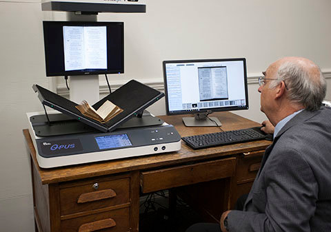 Leavell College professor Ed Steele positions a rare hymnal on the scanner in New Orleans Baptist Theological Seminary John T. Christian Library. JOE FONTENOT/BP